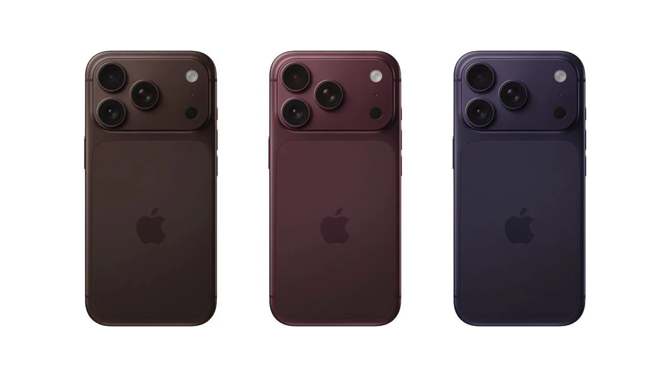 Three modern smartphones shown from the back in dark brown, burgundy, and deep navy colors, each with two large camera lenses in the upper left corner and Apple logo centered