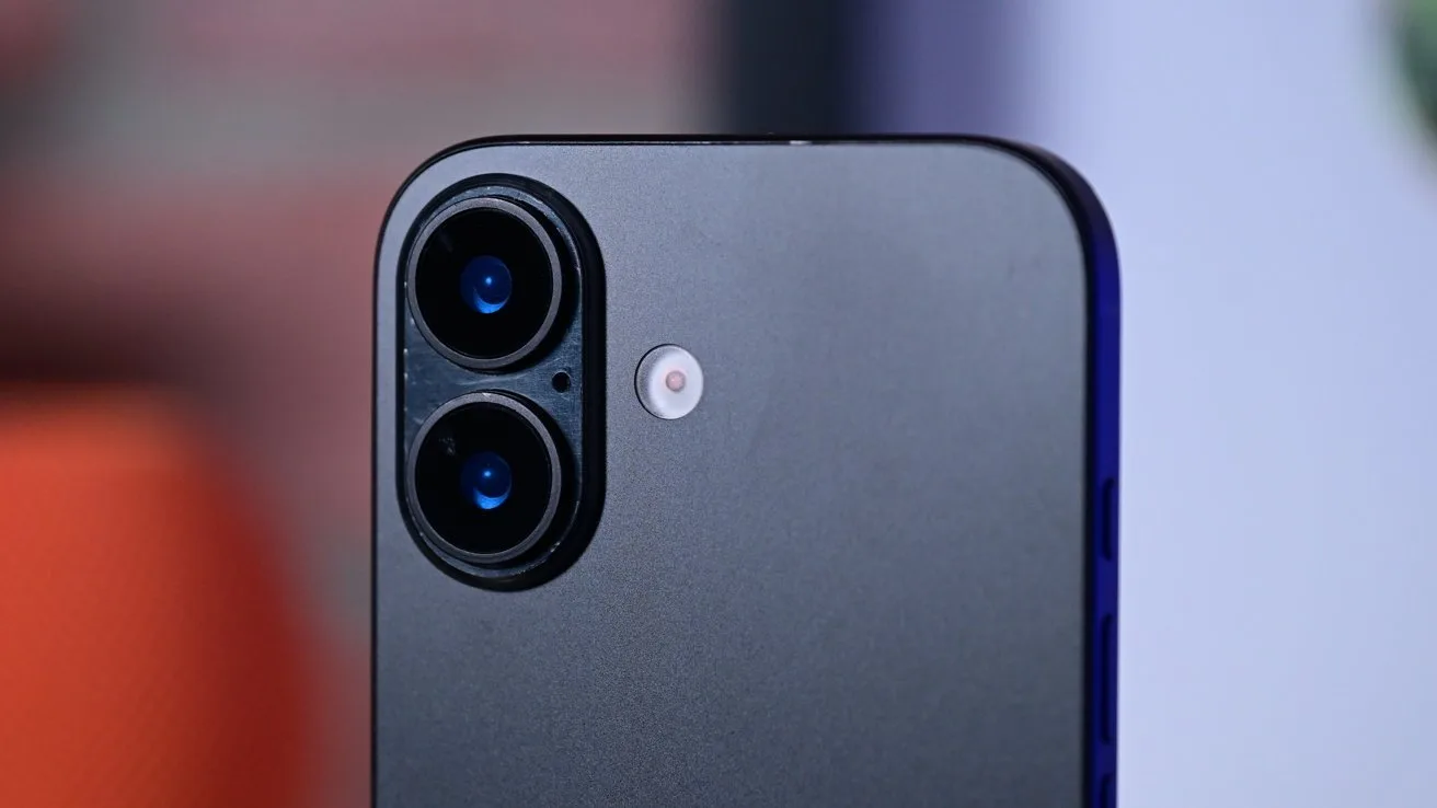 Close-up of a modern smartphone's back, showing a matte gray finish with two stacked camera lenses and a small flash beside them, against a softly blurred background