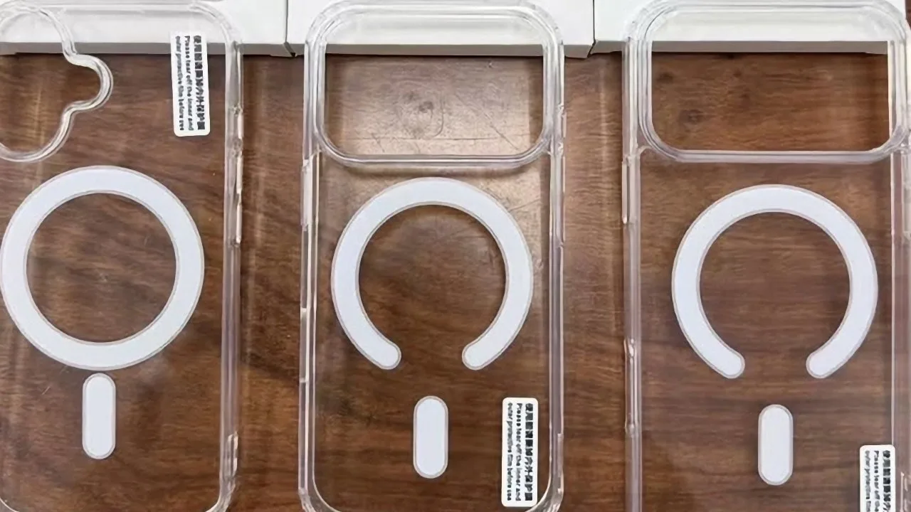 Three clear smartphone cases with white MagSafe-style circular and vertical alignment markings, arranged side by side on a wooden surface, each shaped for a different camera layout