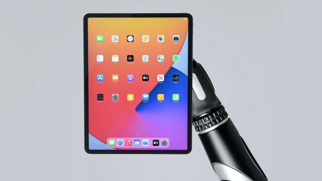 Robotic hand holding a tablet with colorful home screen icons on a gradient orange and purple background, centered against a plain light gray backdrop