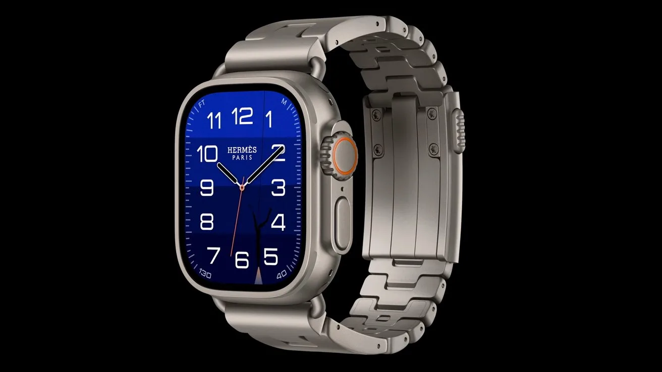 Silver metal Apple Watch with Hermes branding, blue analog watch face, white numerals, and a linked metal band, displayed against a solid black background.