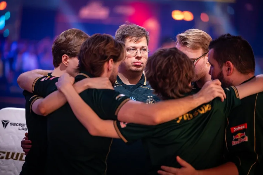 The photo features Counter-Strike pro players from Team Falcons: team-bonding hug ahead of a match at the CS2 Esports World Cup 2026 (EWC 2026).