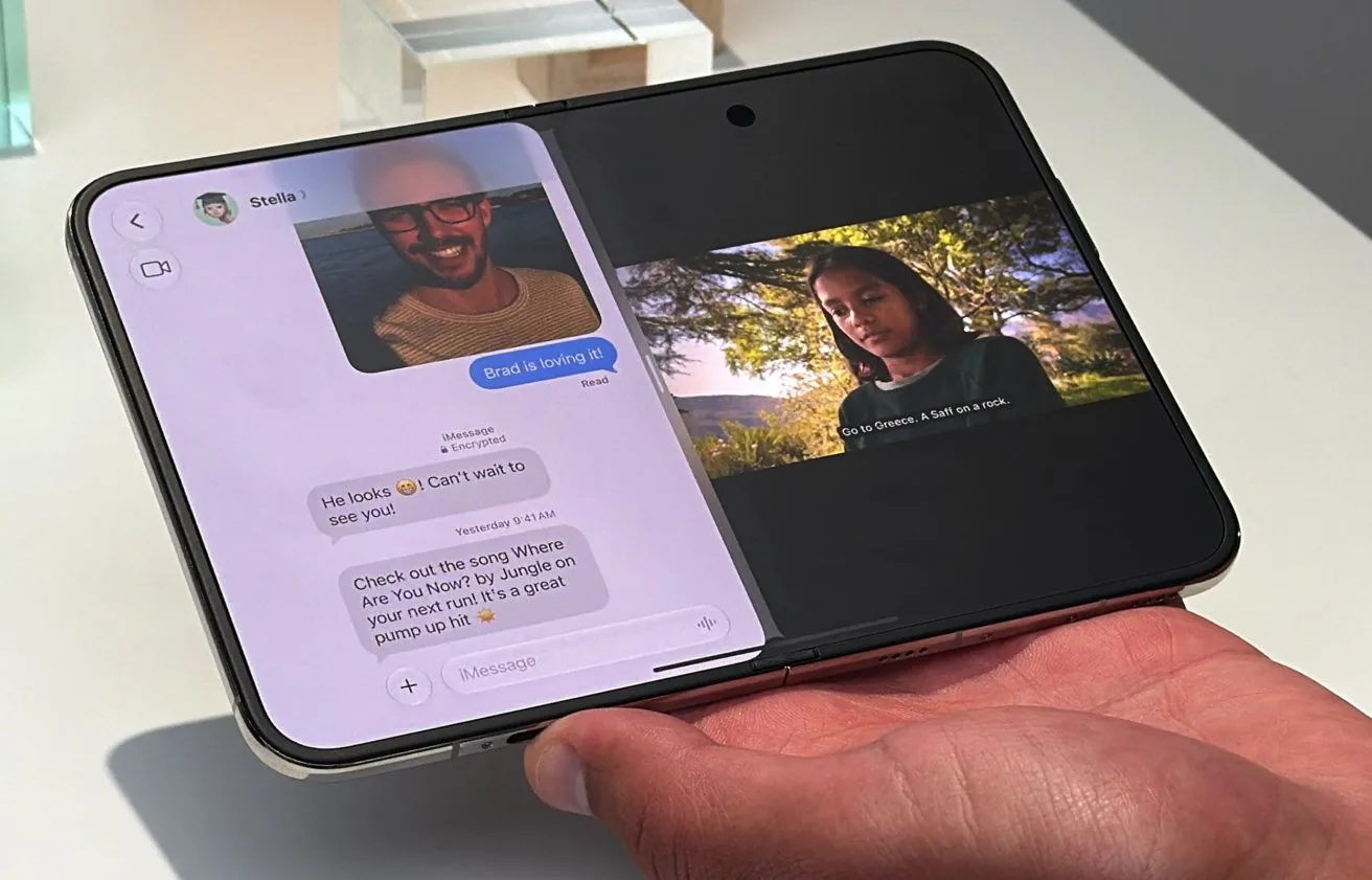 Foldable smartphone held in one hand, screen split showing a text messaging conversation with profile photo on the left and a paused video of a woman outdoors on the right