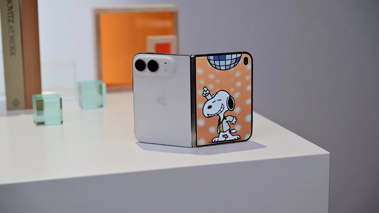 iPhone Duo on a white table, half showing a plain white back with dual cameras, the other half a colorful Snoopy party illustration with orange background and disco ball