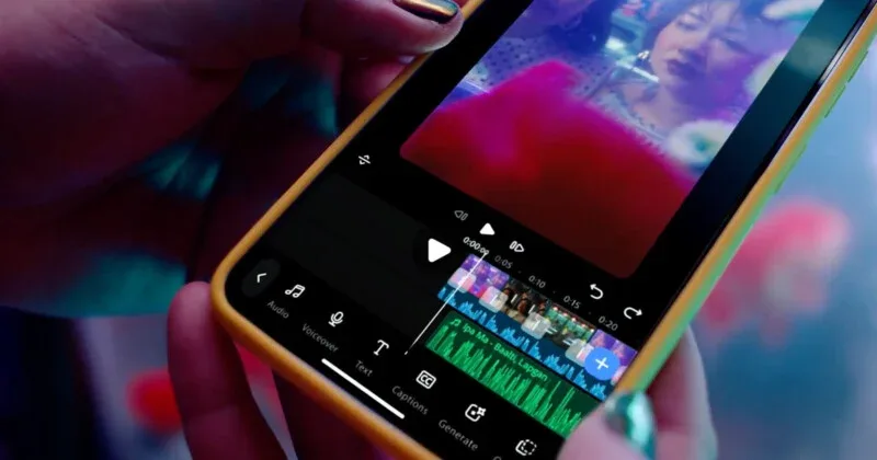 A close-up view of a person holding a smartphone displaying a video editing interface with a timeline, audio track, and editing tools.