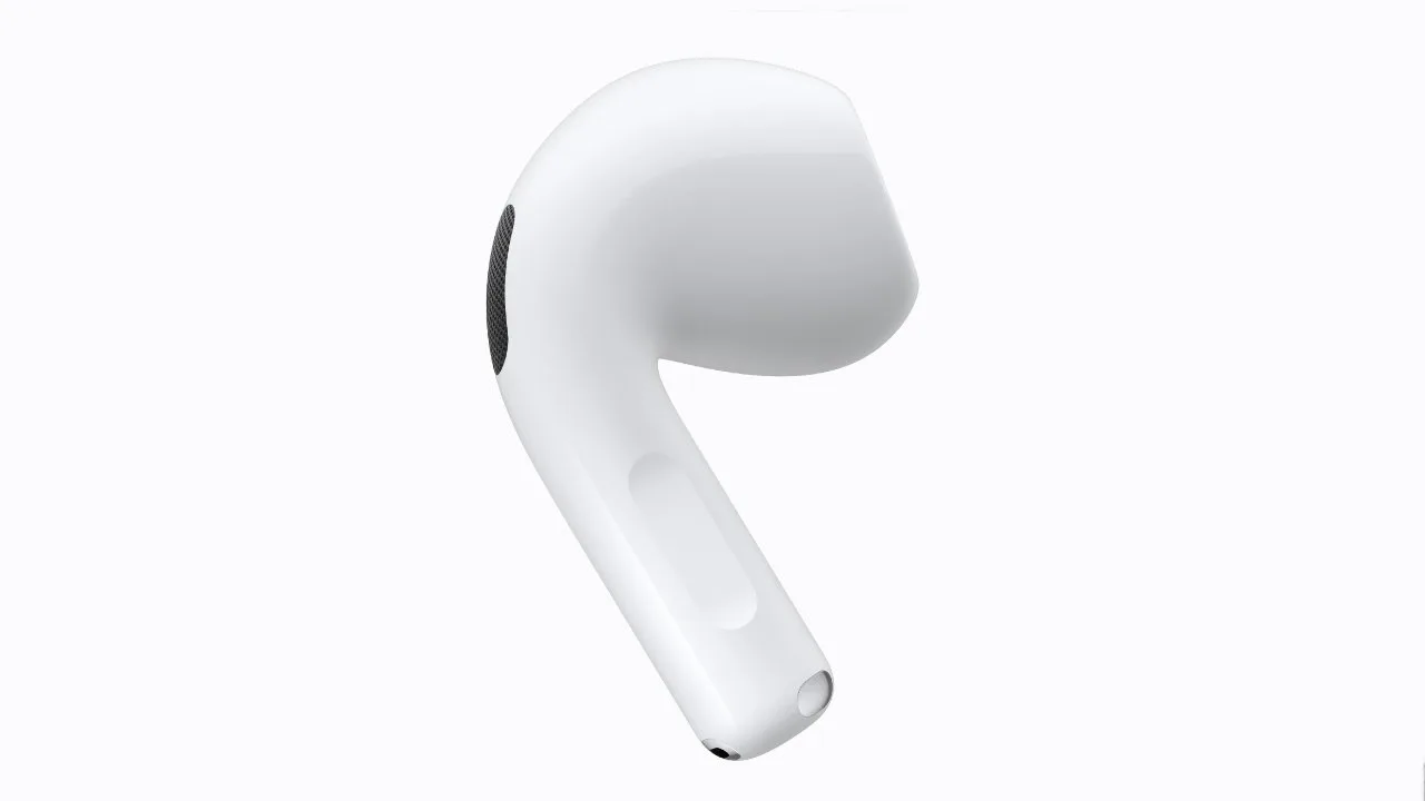 Single white wireless earbud with smooth curved shape, small black sensor area, and silver charging contact at the tip, shown on a plain light gray background