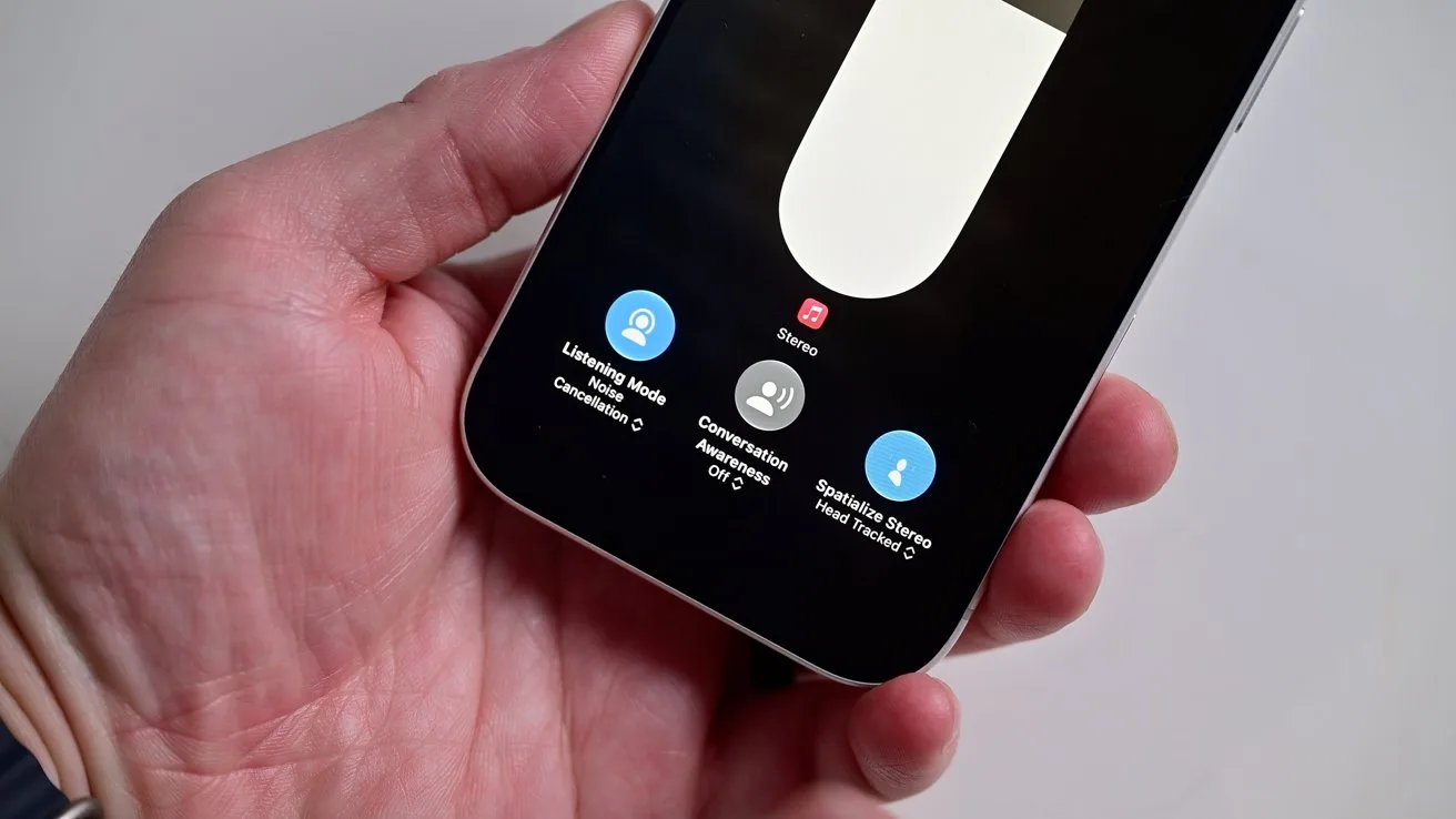 Hand holding a smartphone displaying a recording interface with a large white slider and three blue circular control buttons near the bottom on a dark screen