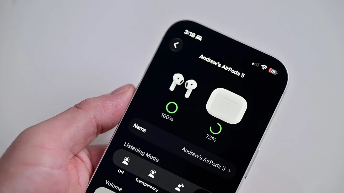 Hand holding an iPhone showing the AirPods settings screen, displaying battery levels for wireless earbuds and charging case on a dark interface with various listening mode and volume options
