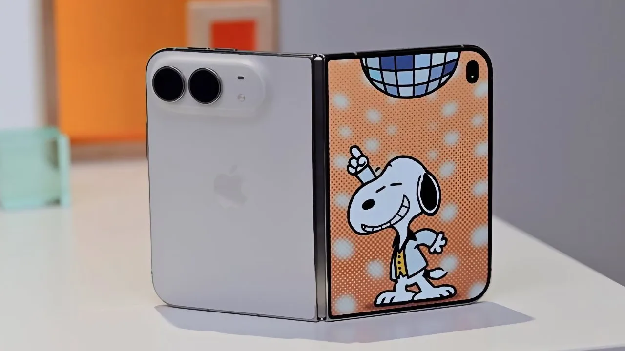Foldable smartphone standing partly open, one side showing Apple-style dual cameras, the other side decorated with dancing Snoopy under a disco ball on an orange, dotted cartoon background