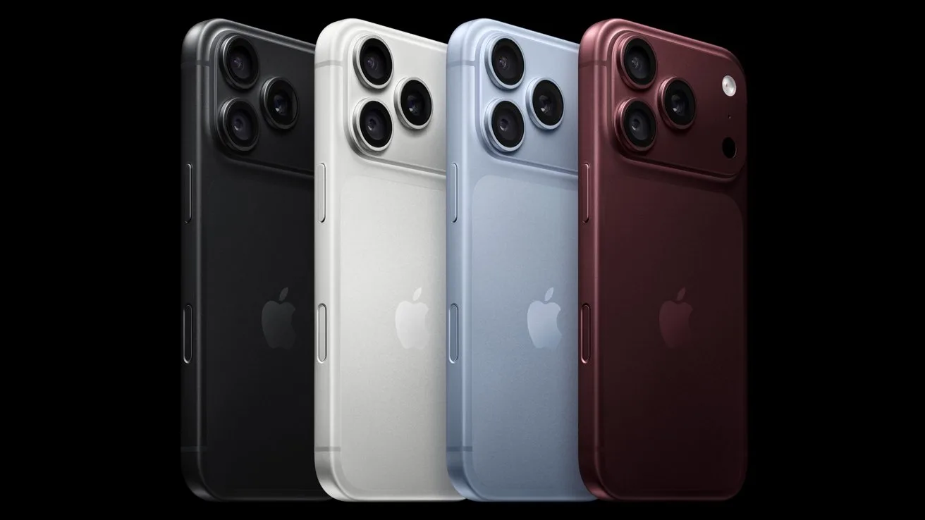 Four modern Apple smartphones standing upright in a row, showing backs with triple camera lenses, in black, silver, light blue, and deep burgundy colors against a dark background