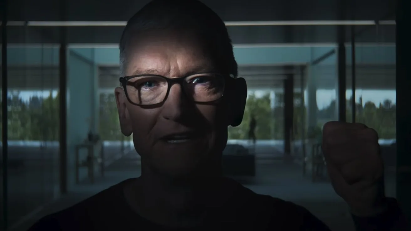 Middle-aged person with glasses lit dramatically from above, standing indoors, raising a clenched fist, with large windows and a bright outdoor scene visible in the background