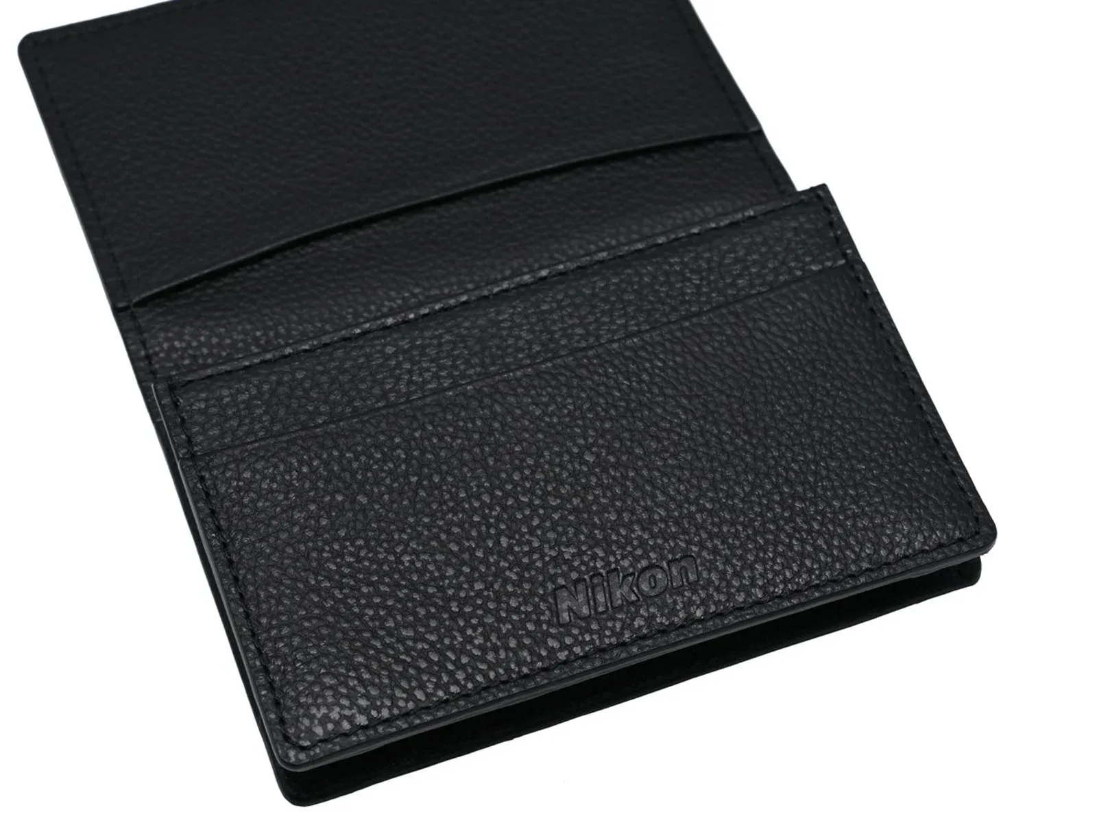 A black leather card holder with a pebbled texture and the Nikon logo embossed on the front pocket.