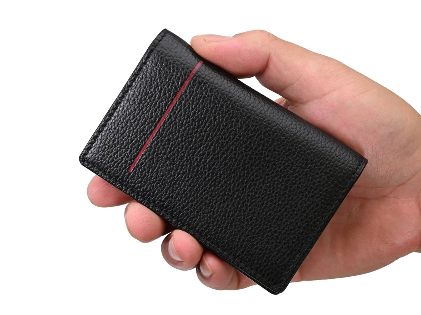 A hand holds a black, textured leather card holder featuring a single vertical red accent line.