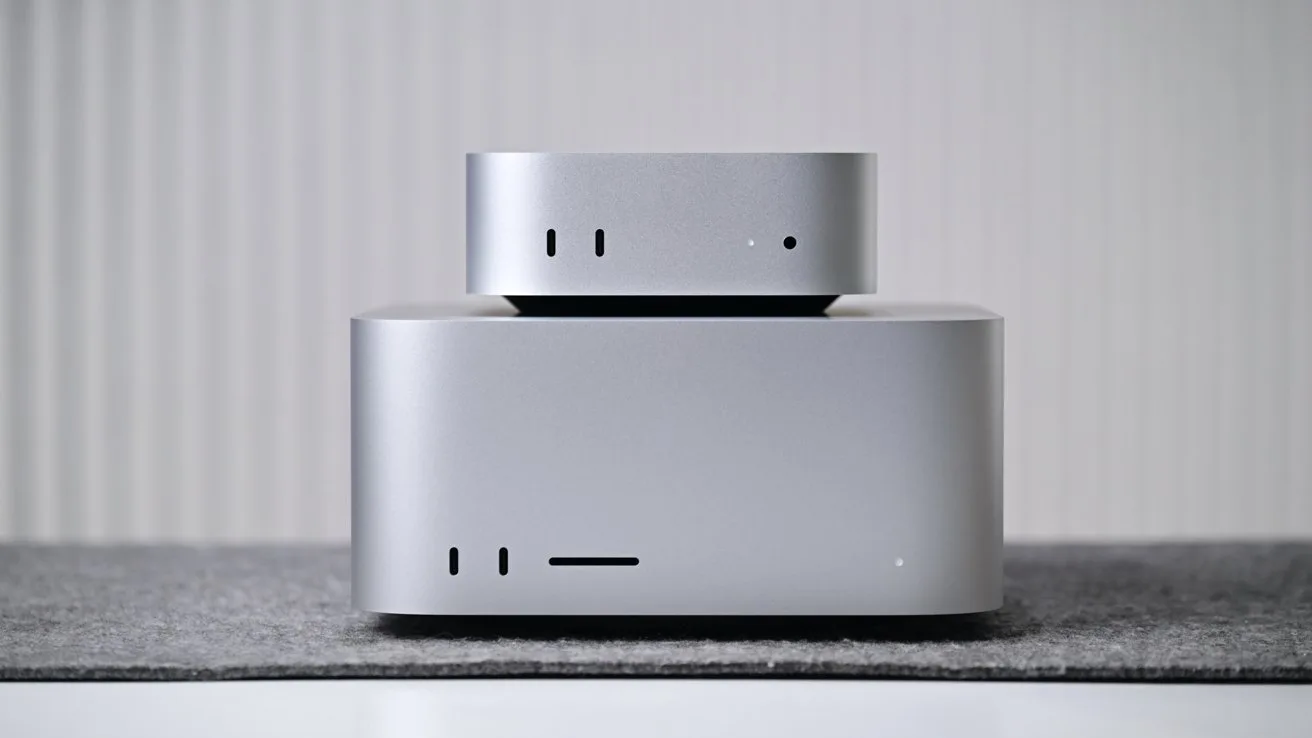 Mac mini on a Mac Studio, stacked, placed on a gray surface against a softly lit vertical-striped white background