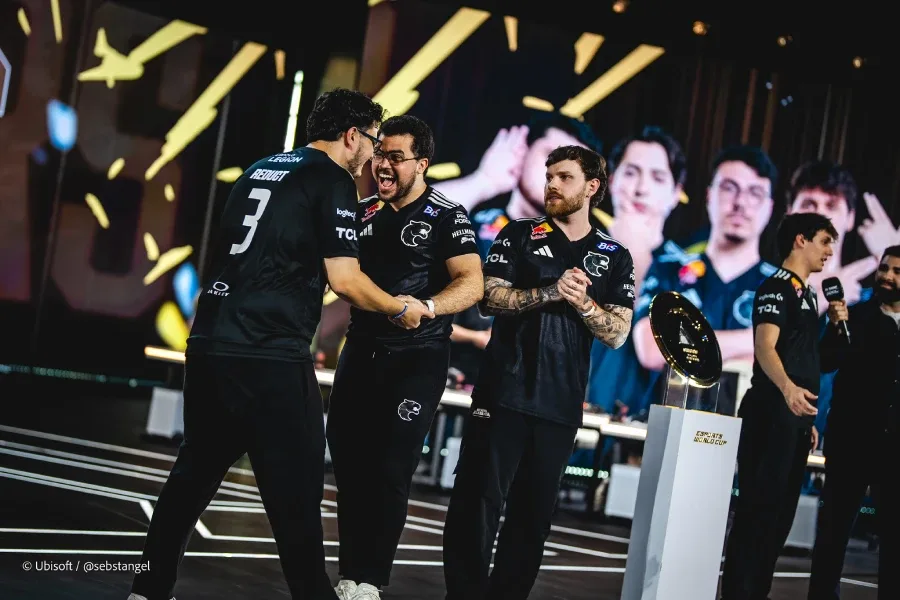 The photo features Rainbow Six Siege pro players from the team FURIA — happy on the stage of R6 Esports World Cup 2026 (EWC 2026), after a successful playoff match.